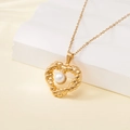 Golden twisted heart pendant necklace with white pearl inlay on a soft geometric background - 137518-Gold Twisted Heart Pearl