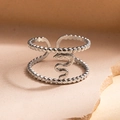 Detailed macro shot of silver stainless steel open ring with snake pattern and beaded texture - Steel Color Style 4