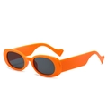 Vintage oval orange frame sunglasses with dark lenses shown from a 45-degree angle - Orange Frame Black Grey Lens
