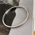 Minimalist silver stainless steel oval bangle with polished finish and hinge clasp closure - Silver