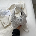 White quilted canvas crossbody bag with frayed fringe texture and silver metal clasp - Off White