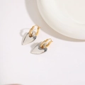 Close-up of heart earrings with two-tone silver and gold plating and zircon inlay - Two-tone Plating