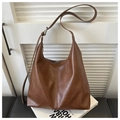 Brown large capacity PU leather tote bag with adjustable strap on a minimal white background - Brown