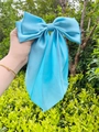 Macro detail of large sky blue satin bow hair clip with glossy texture and metal spring - Scarf Bow / Sky Blue