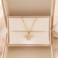 Detail of gold heart pendant with wings and sparkling center stone in jewelry box - Gold Wing Heart Style (A-1062)