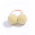 Kids hair tie featuring soft yellow pom-poms and a durable pink elastic band - Yellow with Pink Band