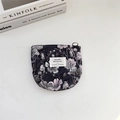 Detail of vintage floral jacquard makeup bag with purple flowers on white background - Elegant Black Floral With Silver Thread