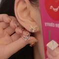 Close-up of minimalist silver butterfly stud earrings with colorful zircon stones on ear - Multicolor Zirconia Hollow Butterfly Earrings