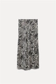Detail shot of midi skirt featuring a black and white zebra pattern and silky texture - Zebra Print