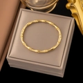 Polished gold bamboo style titanium steel bangle on a premium jewelry gift box - Gold Bamboo Knot Open Bangle