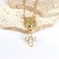 Macro detail of gold Saint Benedict medal and cross pendant with zircon stones - Style 7