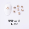 Macro detail of 4.3mm champagne gold rhinestone flower charms for nail art design - Light Brown Champagne (AM46)
