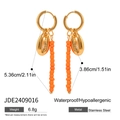 Detail view of gold stainless steel earrings with seashell charms and orange beads - Shell Orange Bead And Tassel Charm Style (JDE2409016)