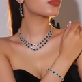 Silver bridal jewelry set featuring green crystal flower necklace and earrings on a model - Necklace + Earrings + Bracelet / Green Gem 3-Piece Set(DTN14026404-3EM)