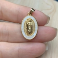 Oval gold Jesus pendant with white shell inlay held by hand to show size and detail - White