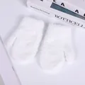 Close-up of soft white coral fleece mittens for kids with fluffy plush texture - S / White