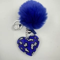 Close-up of blue plush ball keychain with a leopard print rhinestone heart charm - Blue