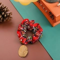 Red plaid Christmas scrunchie with white snowflake patterns on a festive fabric base - Red Plaid Snowflake