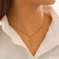 Close-up of gold hollow cross necklace pendant on model neck with O-chain detail - Hollow Cross Necklace (5798) / Titanium Gold