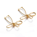 Detail of creative gold wire-wrapped bow earrings with a minimalist irregular design - Gold