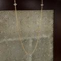 Close-up of golden necklace featuring five light blue clover charms on a vintage chain - Clover Necklace / Gold Blue