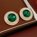 Macro detail of emerald green glass earrings with sparkling rhinestone halo and gold finish - Silver Earring Post-Green