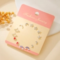 Set of 9 pairs of silver steel stud earrings featuring star, moon, and rainbow designs - Silver Colorful Planet (E1935-1)