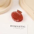 Shell shaped hair claw clip in translucent red resin with sparkling glitter finish - Red with Logo