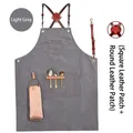 Light grey canvas work apron with brown leather cross-back straps and multi-pocket design - New Leather Strap Thick Light Grey Canvas with Loop