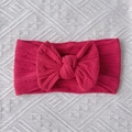 Detailed close-up of dark pink cable-knit nylon baby headband with large bow detail - Burgundy