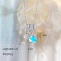 Silver necklace featuring a blue cat's eye stone pendant with sparkling zircon accents - Silver-Round Iridescent Rhinestone Necklace