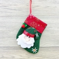 Mini Christmas stocking featuring a Santa Claus motif and green felt fabric with snowflake patterns - Snowflake Small Stocking (Santa Style)