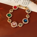 Detail of vintage gold bracelet with colorful gemstones and pavé crystal accents - Colorful