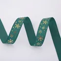 Close-up of dark green grosgrain ribbon with festive gold snowflake patterns and ribbed texture - Gold Stamping Green Snowflake (2.5cm Width 5m Length)