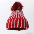 Detail of red knit hat with rows of iridescent rhinestones and a fluffy pom-pom - Red