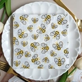 Square party napkins with cartoon bee prints on an elegant white ceramic plate - Cartoon Bee (1101)