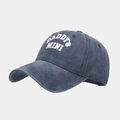 Detail view of washed denim texture and white DADDY'S MINI print on the baseball cap - Adjustable / Navy Blue