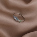 Close-up of pearl and zircon flower ring with blue and green gems on brown silk - Blue Rhinestone Butterfly (Silver) (21699D)