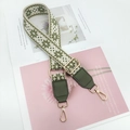 Close-up of adjustable woven bag strap with green snowflake pattern and gold metal hooks - Army Green with Army Green Leather