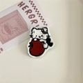 Close-up of embroidered white cat holding a red apple patch for clothing decoration - Apple