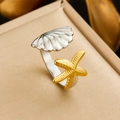 Macro shot of silver shell and gold starfish details on a mixed-metal open ring - Shell & Starfish Combined Design (R567)