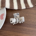 Chic marble pattern acetate bow hair claw with gold lettering in a vintage setting - Marble White