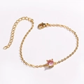 Detailed close-up of a gold-tone bracelet with a pink zircon and adjustable lobster clasp - Pink Zirconia (Round Pink)
