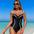 Slimming black one-piece swimsuit with white trim and thin straps in a beach setting - S / Black and White