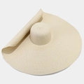 Detailed close-up showing the fine straw weave and wide wavy brim of this beige sun hat - Beige