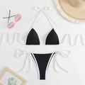 Flat lay of black and white string bikini set with beach hat and gradient sunglasses - Black + White Cord