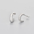 Detail view of silver stud earrings with baguette-cut cubic zirconia and butterfly backings - White Gold / White Zircon