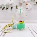 Detail of acrylic milk tea cup keychain featuring a floating turtle in green liquid - Green (Milk Tea Green Turtle)