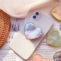 Detail of heart-shaped phone grip with iridescent shell texture and gold plating - Gold Heart Grip / Purple Scallop Shell