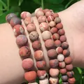 Matte red jasper bead bracelet with natural earthy marble textures on a person's wrist - Frosted Red Stone / 4mm/1 Piece Approximately 90 Pieces/10g